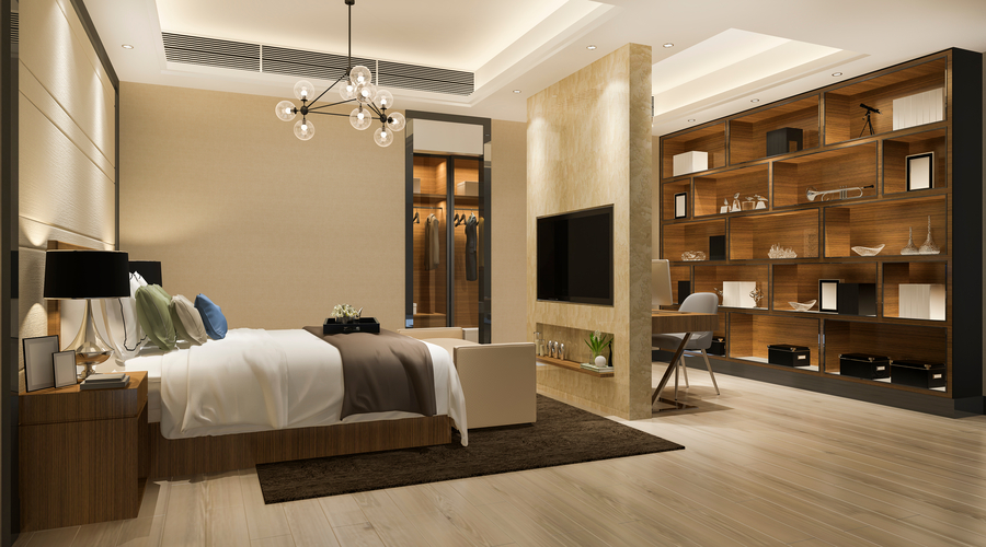 A modern and stylish bedroom with white bedding, nightstands, and a wooden shelving unit along the far wall. The room is illuminated by a modern chandelier and has a warm, neutral color palette.
